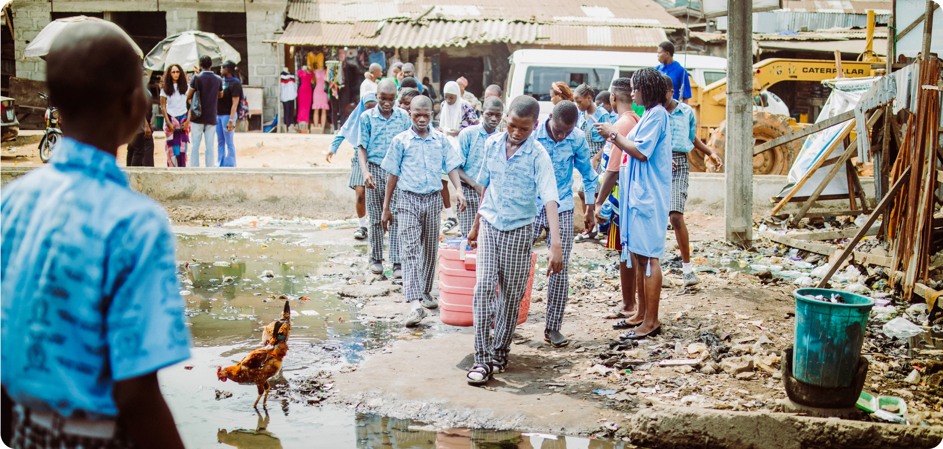 a group of students approaching a water-logged area