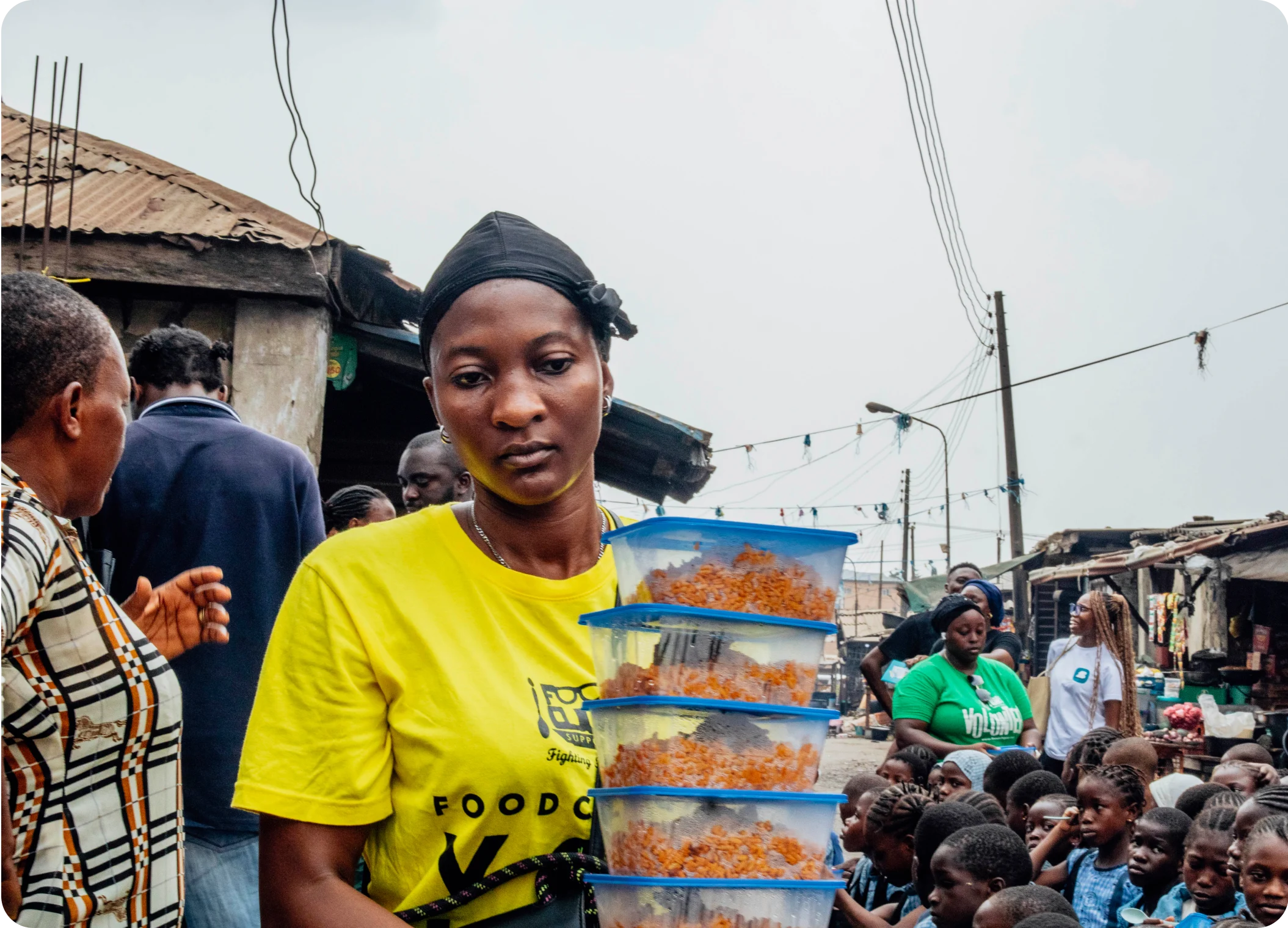 a lady carrying plates of food stacked on top each other