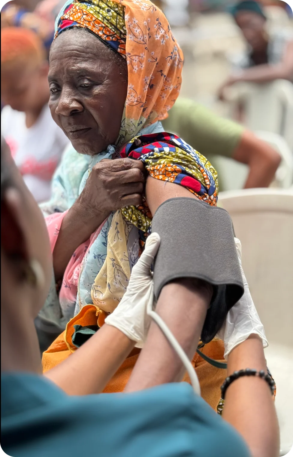 a nurse checking an elderly womans bp